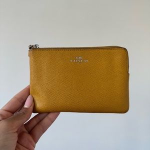 Coach wristlet in mustard colour